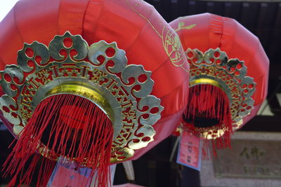 Low angle view of illuminated lanterns hanging in temple