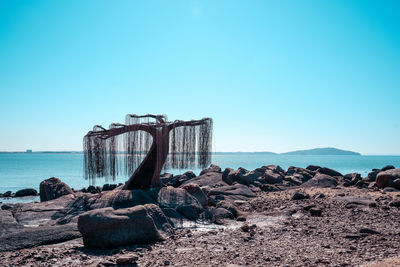 Scenic view of sea against clear blue sky