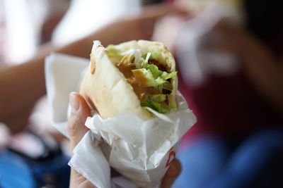 Cropped hand holding shawarma