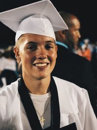 Portrait of happy teenage boy wearing mortarboard graduation ceremony