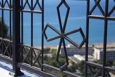 Metallic structure against sky seen through window