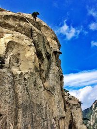 Low angle view of rock formation against blue sky