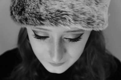 Close-up of young woman wearing fur hat