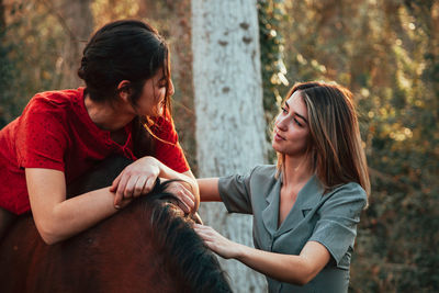 Women with horse in forest