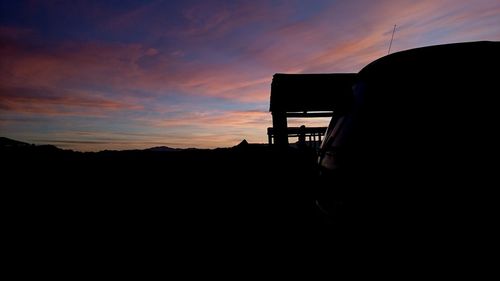 Silhouette landscape against sky during sunset