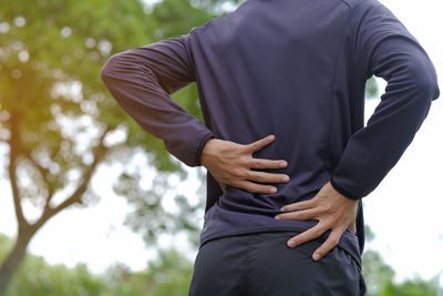 Midsection of man suffering from backache