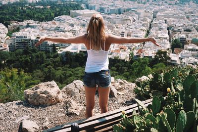 Rear view of woman standing against cityscape