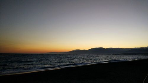 Scenic view of sea against clear sky during sunset