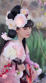 Portrait of young woman holding bouquet