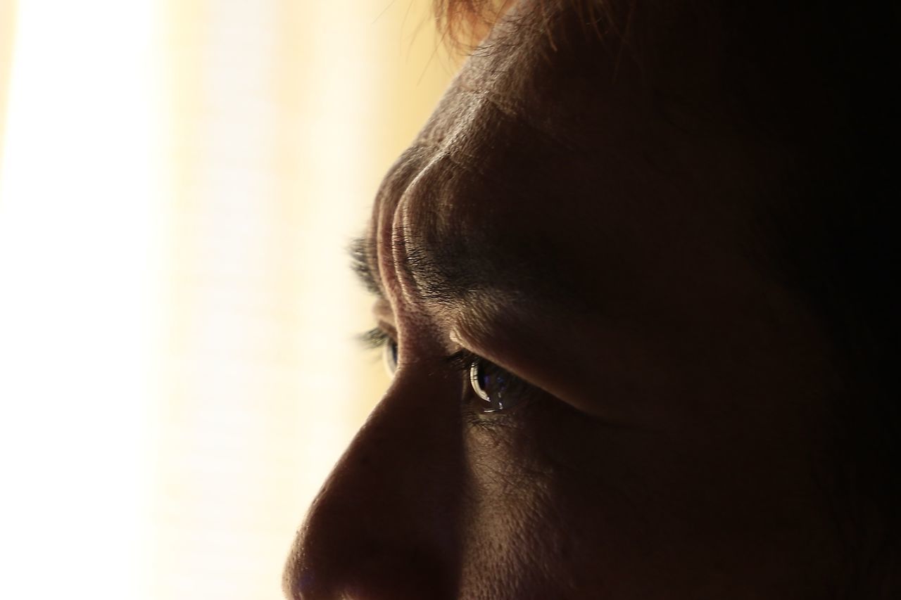 close-up, indoors, part of, studio shot, headshot, side view, person, copy space, animal head, looking away, one animal, human skin, contemplation, human hair, animal body part, cropped, human face