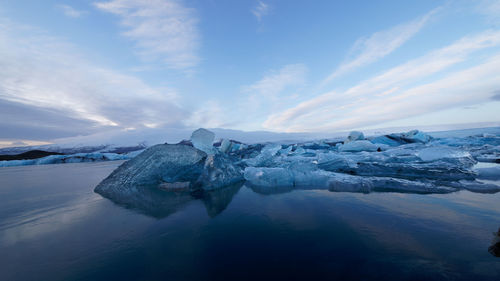 Frozen lake against sky during winter