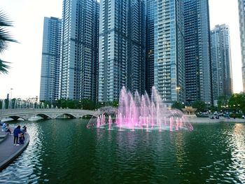 Panoramic view of people in city at waterfront