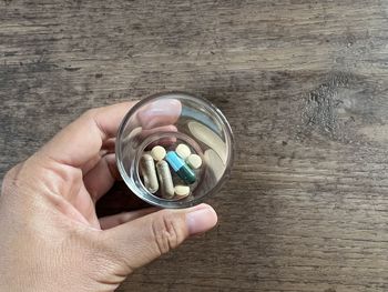 Cropped hand of person holding coin