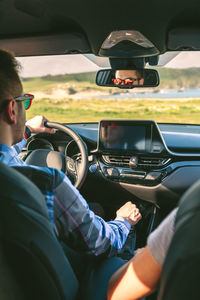 Young couple driving car