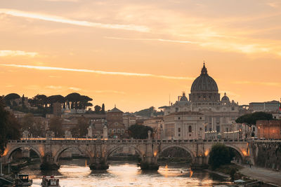 Bridge over river against sky during sunset