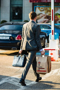 Rear view of man walking on street