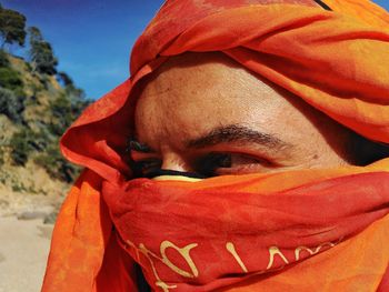 Close-up of man with face wrapped in textile during sunny day