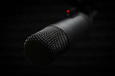 Close-up of lighting equipment against black background