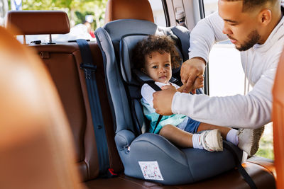 Father with son sitting in car