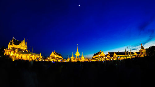 Illuminated city against sky at night