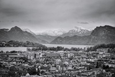 Aerial view of houses and mountains against sky