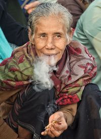 High angle view of woman smoking bidi while looking away