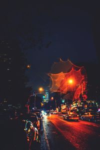 Cars on city street at night