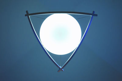 Close-up of illuminated lamp against clear sky