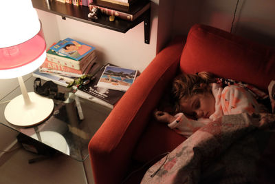 High angle view of girl sleeping at home