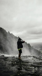 Full length of man standing on sea against sky