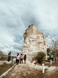 People against rock formation