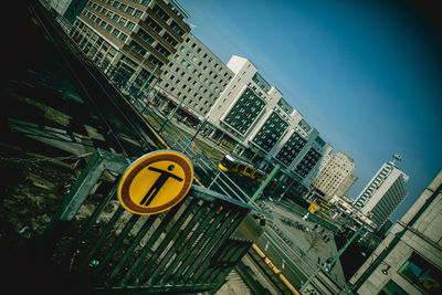 Low angle view of road signs against buildings in city