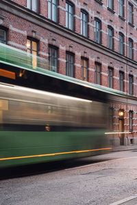 Blurred motion of train against buildings in city