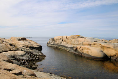 Rocks on beach against sky