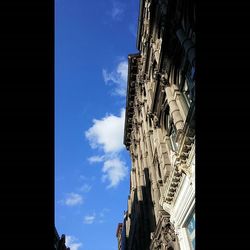 Low angle view of built structure against blue sky