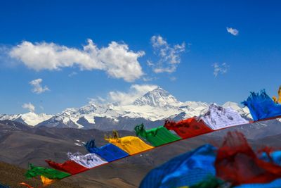 Scenic view of snowcapped mountains against blue sky