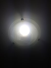 Low angle view of light bulb hanging from ceiling