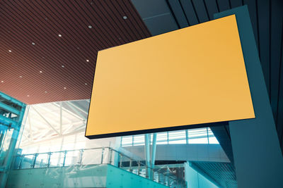 Low angle view of illuminated sign against sky