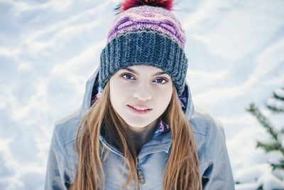 Portrait of a smiling young woman in snow