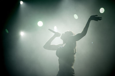 Full length of woman standing in illuminated lights