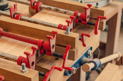 Close up of carpenter fastening board with clamps. carpentry workshop