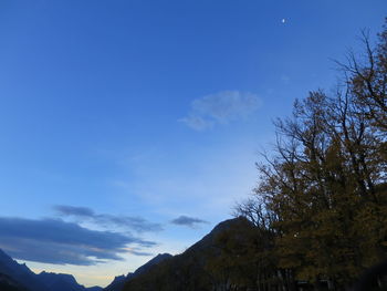 Low angle view of mountain against blue sky