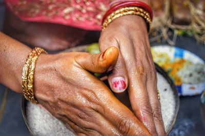 Cropped hands of woman performing traditional ritual