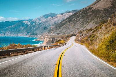 Road amidst mountains against sky