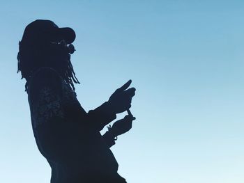 Low angle view of silhouette statue against clear sky