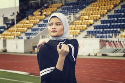 Young woman exercising on running track