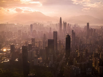 High angle view of illuminated cityscape against sky during sunset