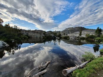 Scenic view of lake by trees against sky