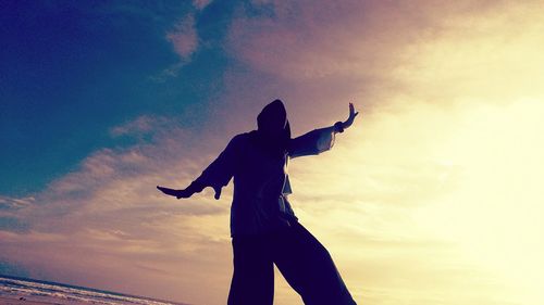 Low angle view of silhouette person against sky during sunset