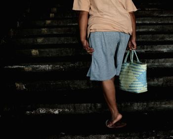 Low section of woman standing on staircase